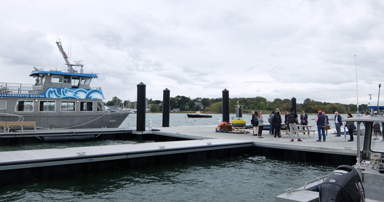 Event attendees gather at Fox Point on the UMass Boston campus.