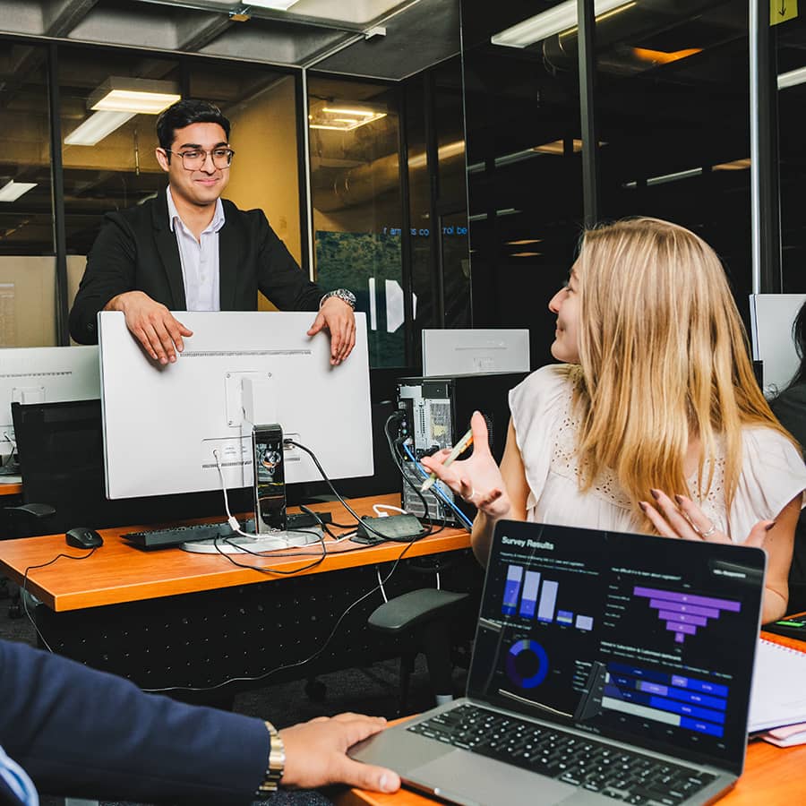 College of Management students working together in the Bloomberg Room.